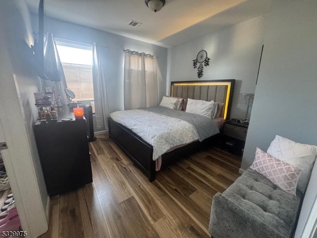 bedroom with dark hardwood / wood-style floors