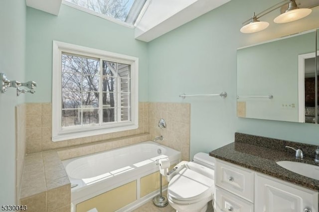 bathroom with toilet, a bath, and vanity