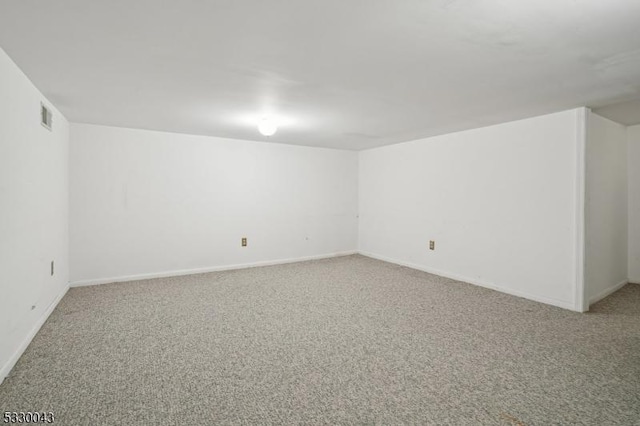 unfurnished room featuring light carpet, visible vents, and baseboards