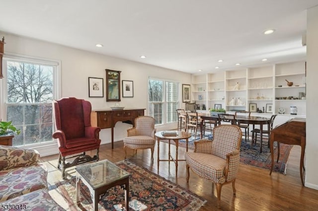 living area with wood finished floors and recessed lighting