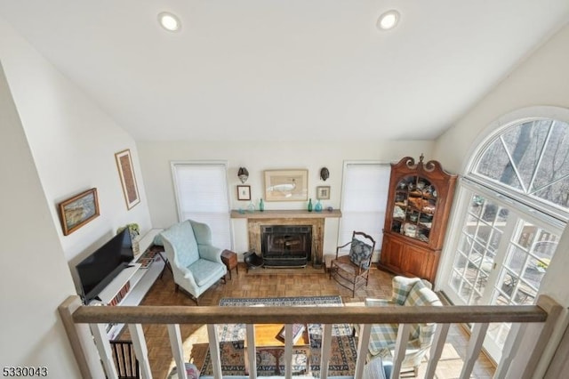 living room with a tile fireplace and recessed lighting