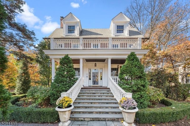 view of front of home with a balcony and a porch