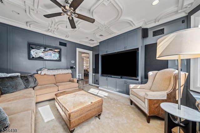 living room with ceiling fan and coffered ceiling