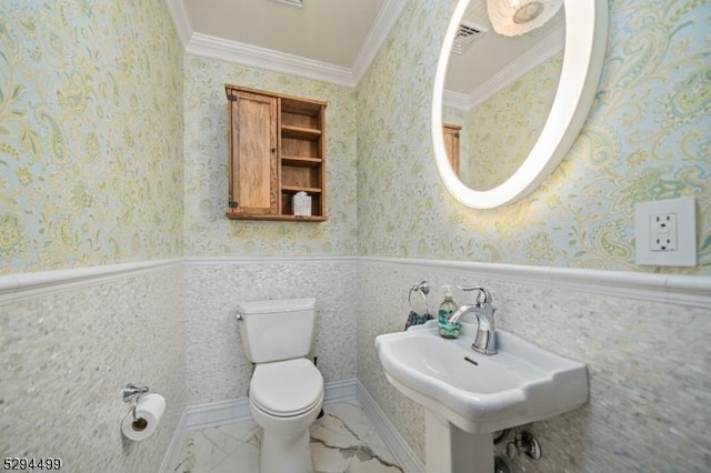 bathroom featuring crown molding, sink, and toilet