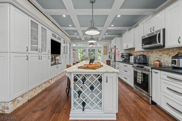 kitchen with white cabinets and appliances with stainless steel finishes