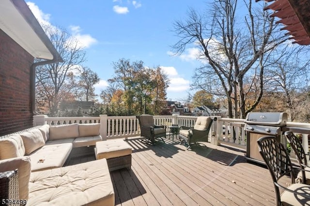 wooden terrace with outdoor lounge area and area for grilling