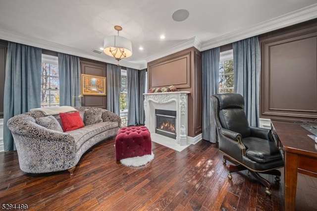 living area featuring dark wood-type flooring and ornamental molding