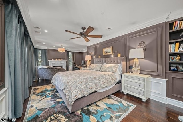 bedroom with dark wood-type flooring, ceiling fan, and ornamental molding