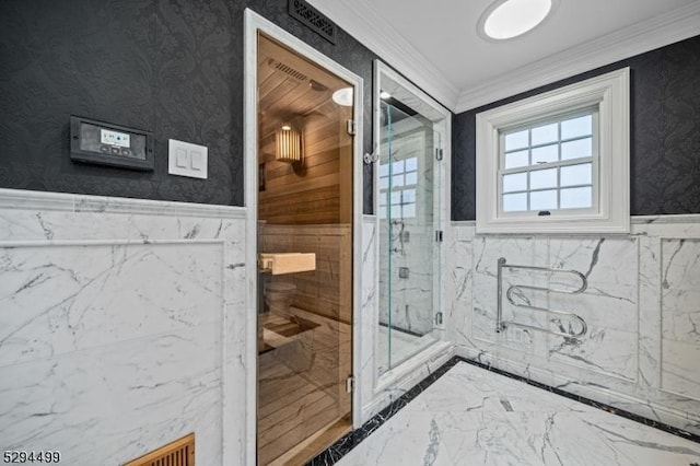 bathroom with crown molding and a shower with door