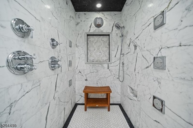 bathroom featuring a tile shower and tile patterned floors