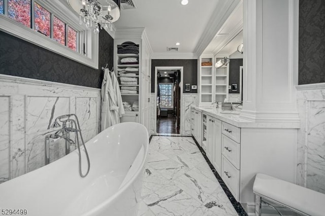 bathroom featuring a washtub, vanity, and ornamental molding