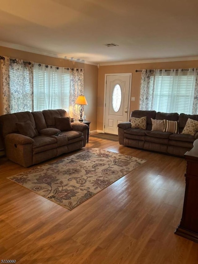 living room featuring hardwood / wood-style flooring and ornamental molding