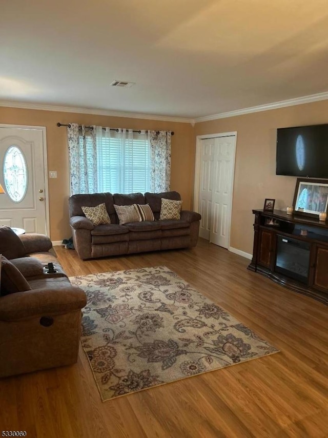 living room featuring crown molding and hardwood / wood-style floors