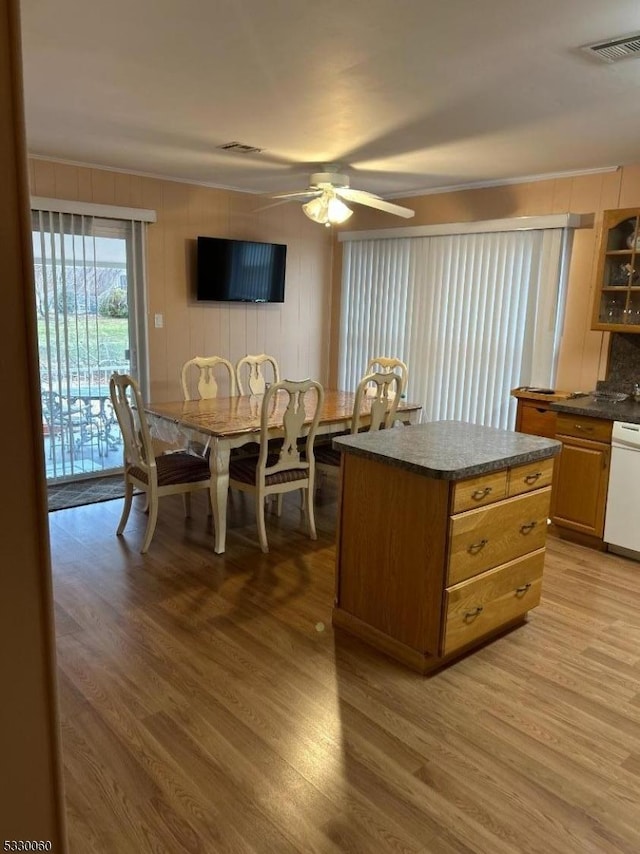 kitchen with dishwasher, light hardwood / wood-style flooring, ceiling fan, and a kitchen island