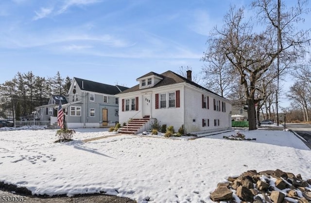 view of snow covered back of property