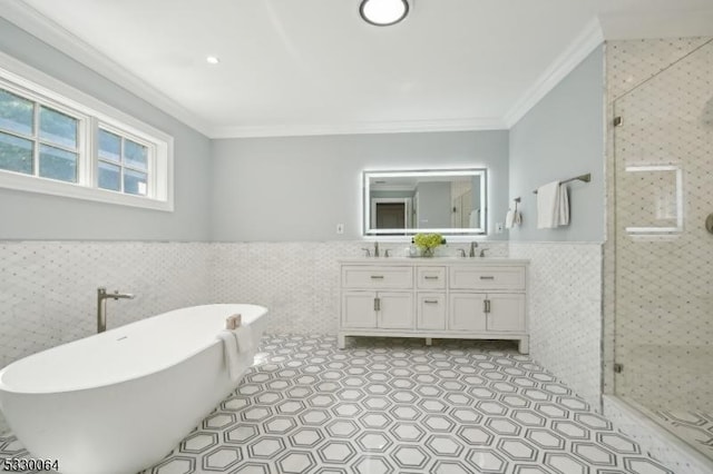 full bath featuring a wainscoted wall, double vanity, ornamental molding, and a shower stall