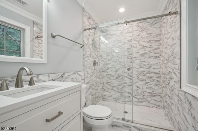 bathroom featuring toilet, visible vents, vanity, a marble finish shower, and crown molding