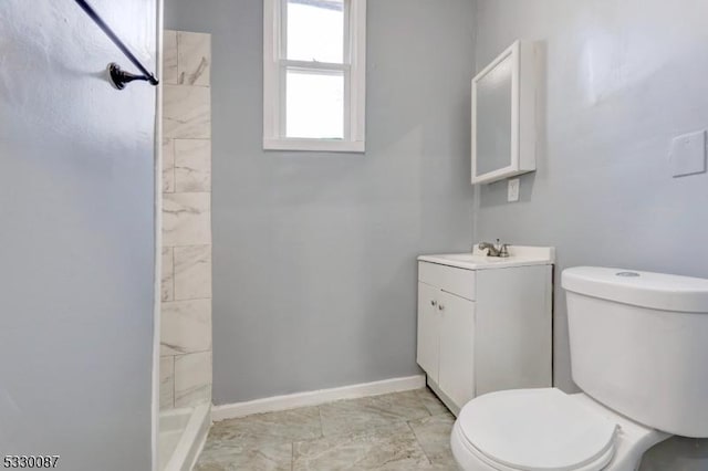 bathroom featuring vanity, toilet, and walk in shower