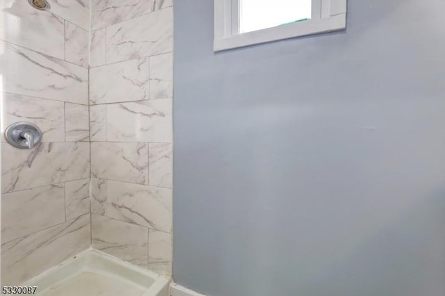 bathroom with a tile shower