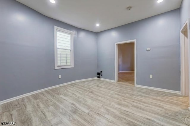 empty room with light hardwood / wood-style flooring