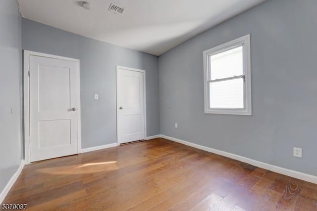 spare room featuring hardwood / wood-style floors