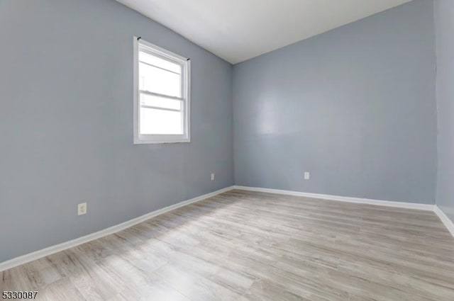 unfurnished room with light hardwood / wood-style floors