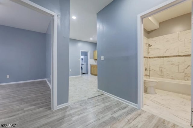 corridor with hardwood / wood-style floors