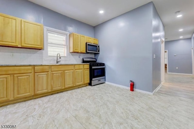 kitchen with decorative backsplash, stainless steel appliances, and sink