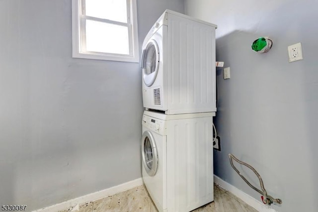 laundry room with stacked washer and clothes dryer