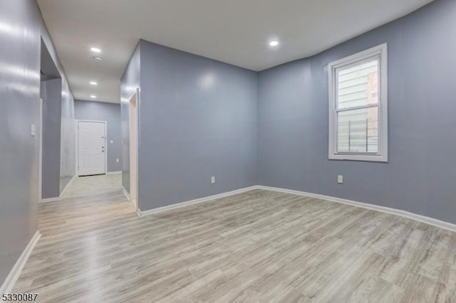 unfurnished room with light wood-type flooring