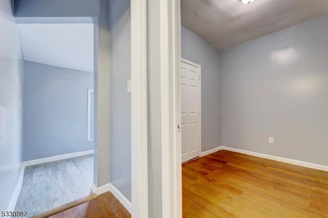 corridor with wood-type flooring