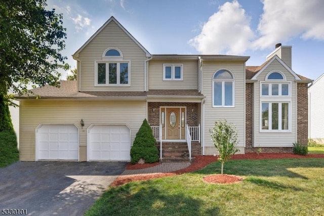 view of front of property with a garage and a front yard