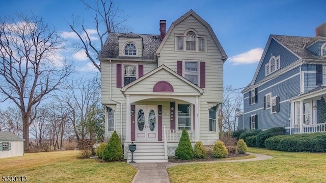 view of front of home with a porch and a front yard