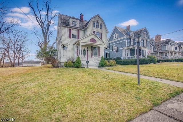 victorian home featuring a front lawn