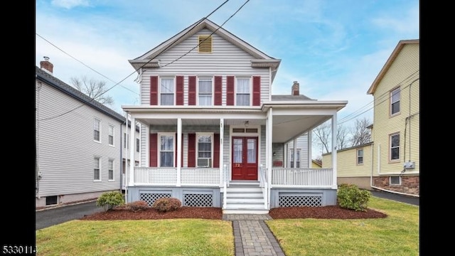 view of front of house with a porch and a front lawn