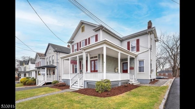 view of front facade featuring covered porch and a front lawn