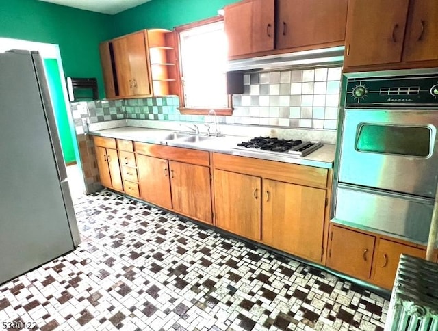 kitchen featuring sink, appliances with stainless steel finishes, and tasteful backsplash