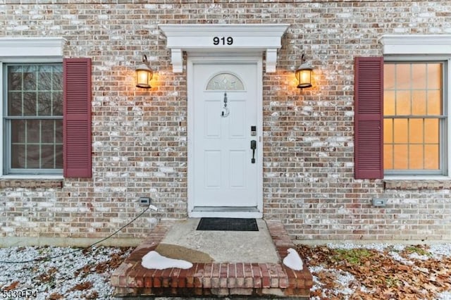 view of snow covered property entrance