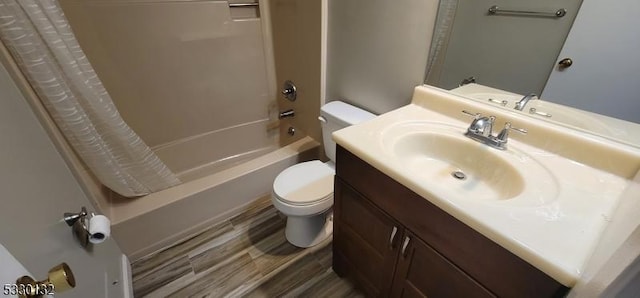 full bathroom with hardwood / wood-style floors, vanity, shower / bath combo, and toilet