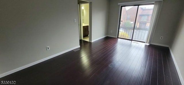 spare room with dark hardwood / wood-style flooring