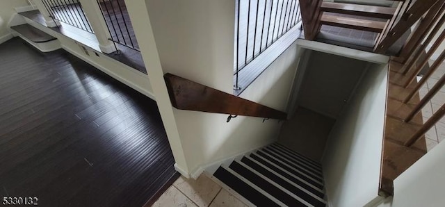 stairway with tile patterned flooring