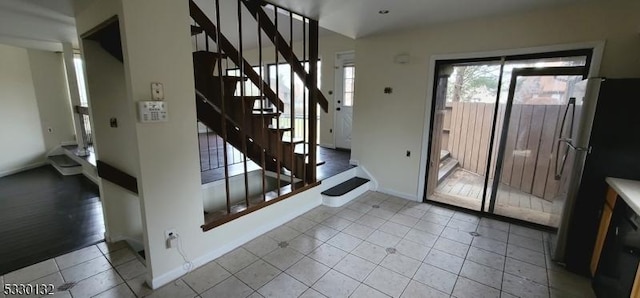 doorway to outside with light tile patterned floors