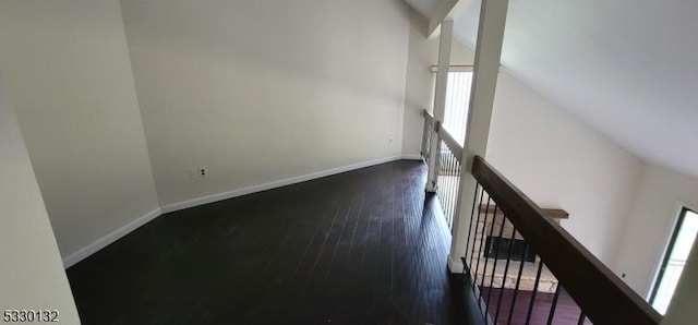 interior space featuring dark hardwood / wood-style floors and lofted ceiling