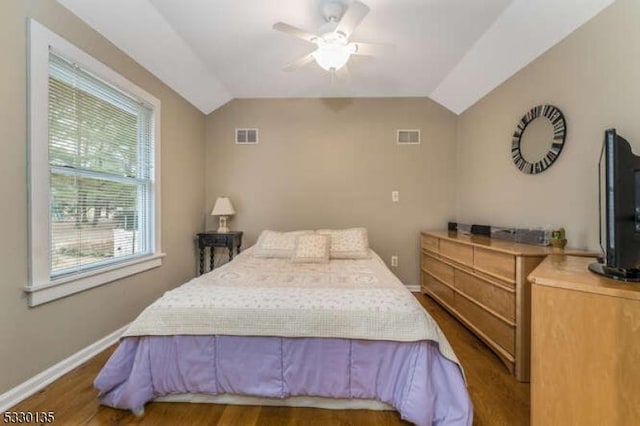 bedroom with ceiling fan, multiple windows, and vaulted ceiling