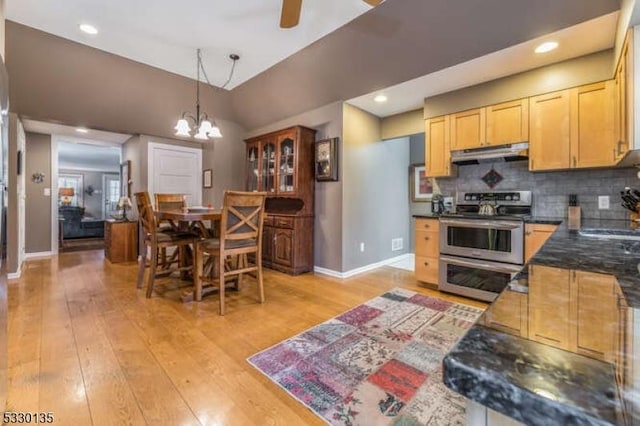 kitchen featuring decorative backsplash, decorative light fixtures, electric range, light hardwood / wood-style flooring, and lofted ceiling