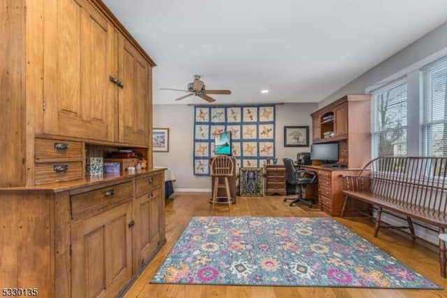 home office featuring ceiling fan and light hardwood / wood-style floors