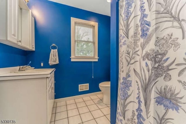 bathroom featuring toilet and tile patterned flooring