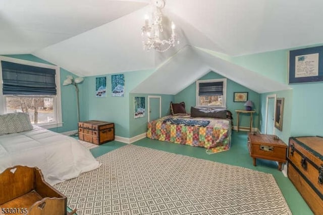 carpeted bedroom featuring multiple windows, a chandelier, and vaulted ceiling