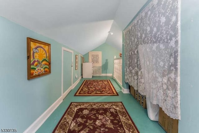 hallway featuring lofted ceiling