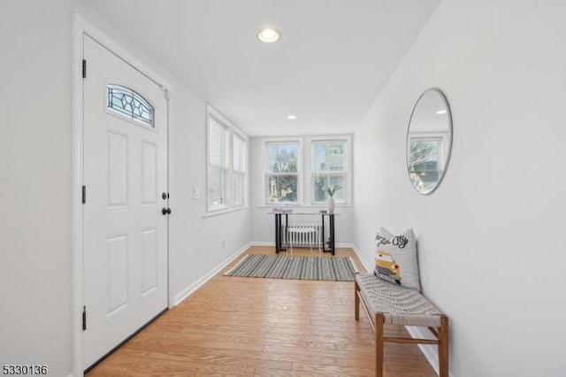 entrance foyer featuring radiator and wood-type flooring